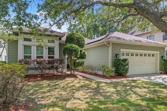 view of front of home with solar panels, a garage, and a front lawn