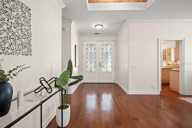 entrance foyer featuring dark hardwood / wood-style floors, crown molding, a textured ceiling, and french doors