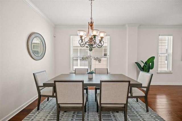 dining area with crown molding, dark wood-type flooring, and a chandelier