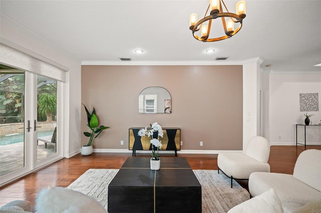 living room featuring a chandelier, wood-type flooring, french doors, and crown molding