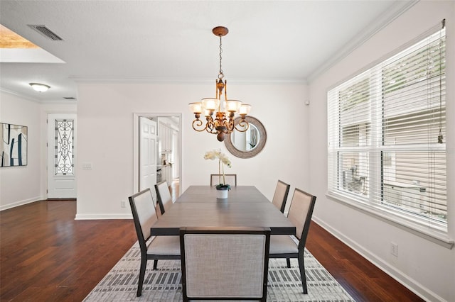 dining area with ornamental molding, dark hardwood / wood-style flooring, and a notable chandelier