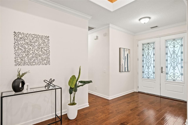 foyer featuring ornamental molding, dark wood-type flooring, a textured ceiling, and french doors