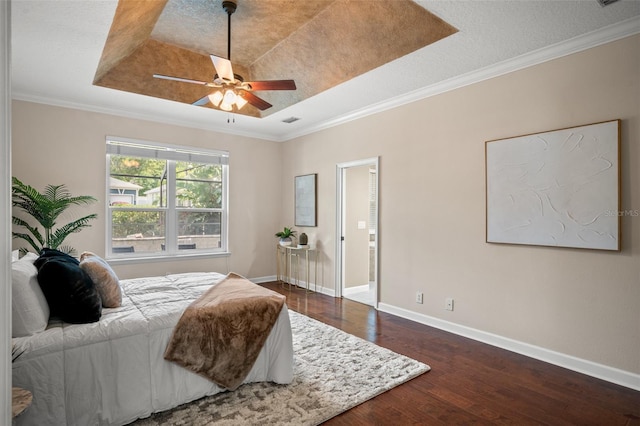 bedroom with a tray ceiling, ceiling fan, and ornamental molding