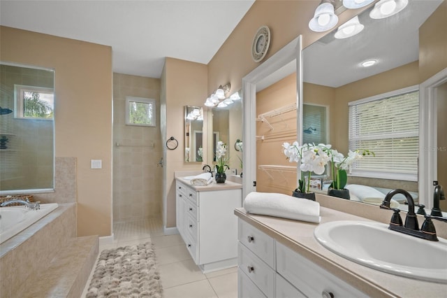 bathroom with plus walk in shower, vanity, and tile patterned floors