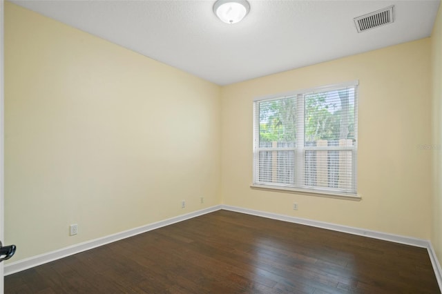 empty room with dark hardwood / wood-style flooring