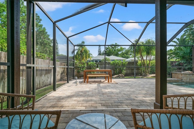 view of patio with a fenced in pool and glass enclosure