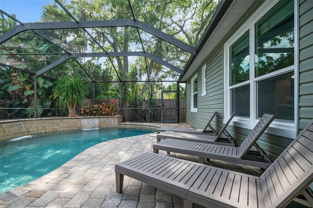 view of swimming pool featuring a lanai, pool water feature, and a patio