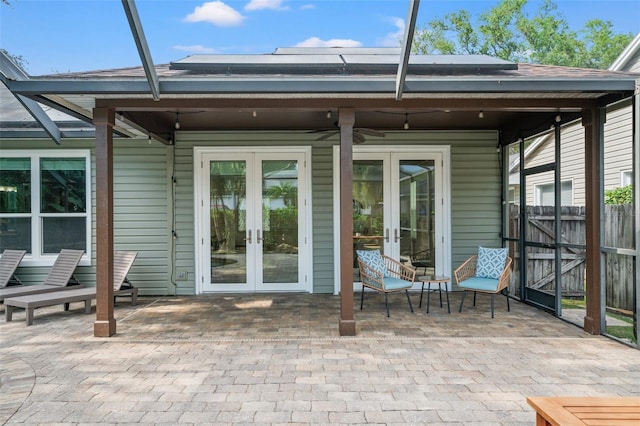 rear view of house featuring french doors, ceiling fan, and a patio area