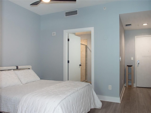 bedroom featuring wood-type flooring, ensuite bathroom, and ceiling fan