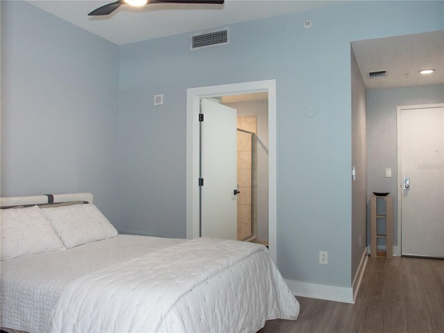 bedroom featuring ceiling fan, baseboards, visible vents, and wood finished floors