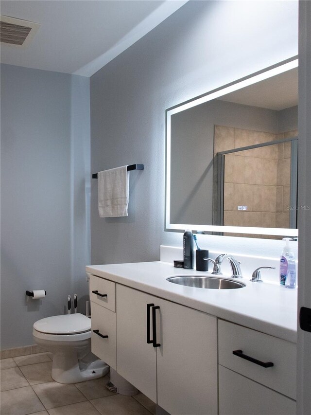 full bathroom with vanity, toilet, tile patterned floors, visible vents, and tiled shower