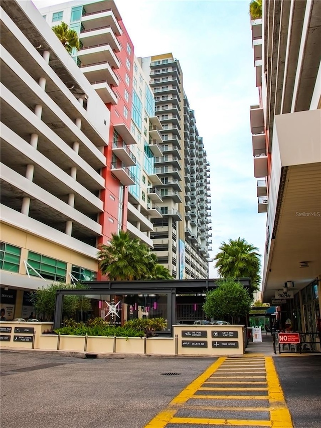 view of building exterior featuring uncovered parking