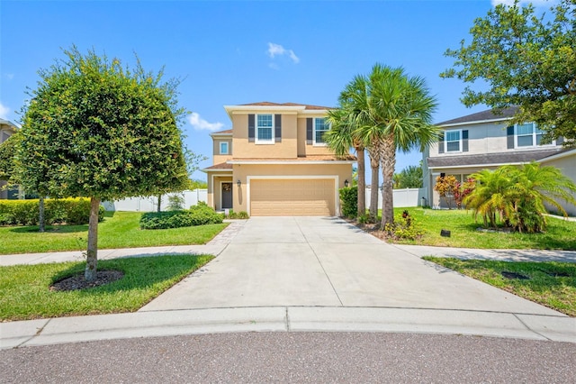 view of front of home with an attached garage, fence, driveway, stucco siding, and a front yard