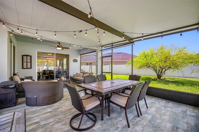 sunroom / solarium with ceiling fan and a healthy amount of sunlight