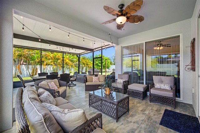 sunroom / solarium featuring ceiling fan and rail lighting