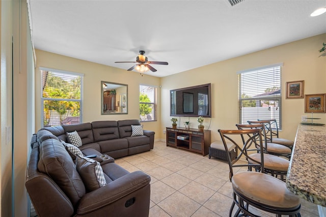 living room with light tile patterned floors and ceiling fan