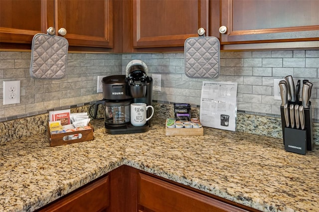 kitchen with tasteful backsplash and light stone counters