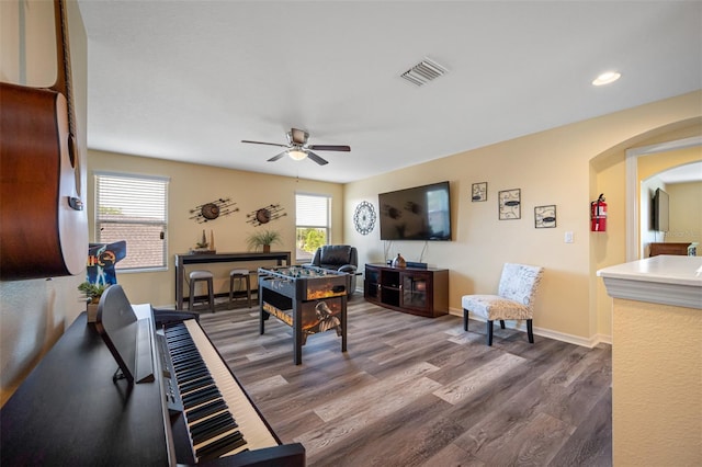 living room featuring dark hardwood / wood-style floors and ceiling fan