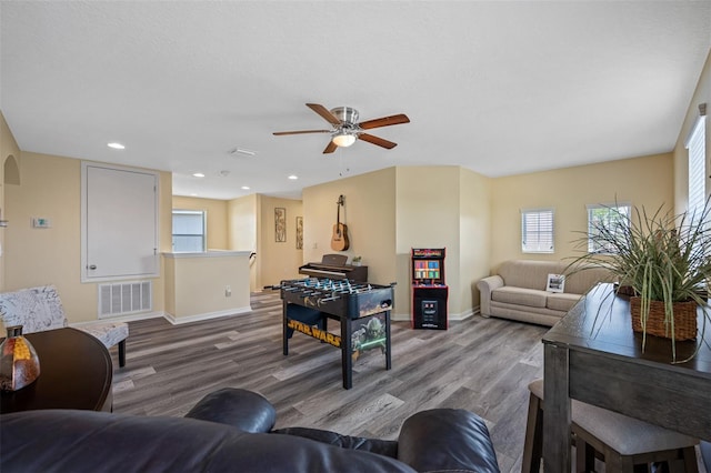 living room with ceiling fan and light hardwood / wood-style floors