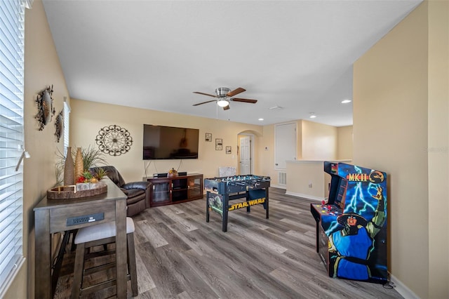 rec room with wood-type flooring and ceiling fan