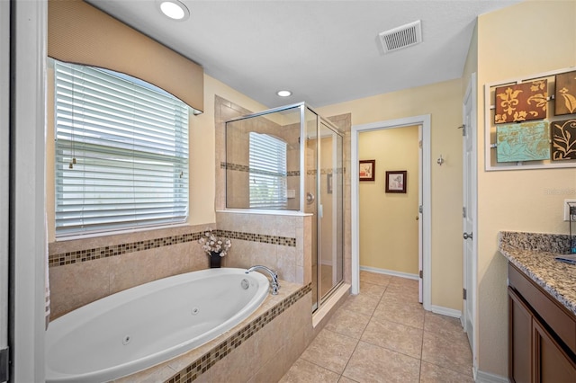 bathroom featuring tile patterned flooring, shower with separate bathtub, and vanity