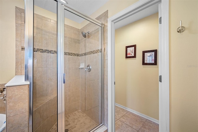 bathroom with tile patterned flooring and a shower with shower door