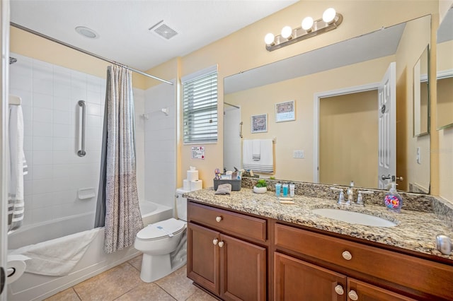 full bathroom with tile patterned floors, vanity, toilet, and shower / bath combo with shower curtain