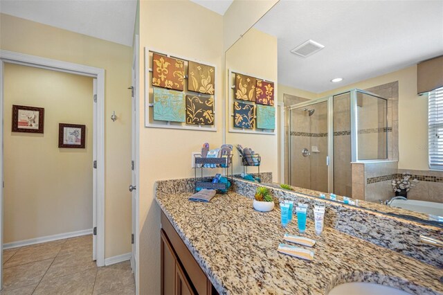 bathroom featuring visible vents, tile patterned flooring, a washtub, vanity, and a shower stall