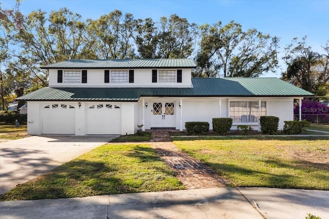 view of property with a front lawn and a garage