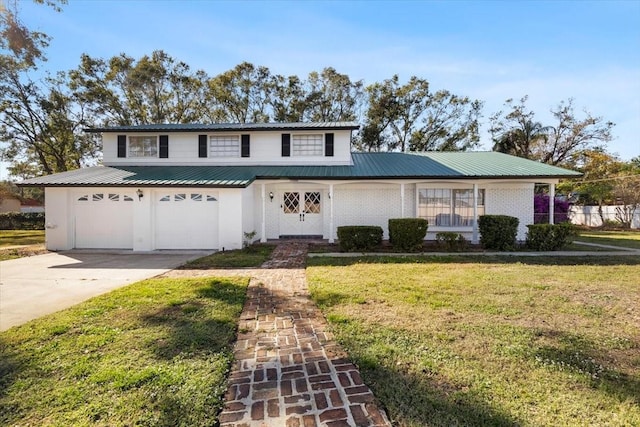 front of property with a garage and a front lawn