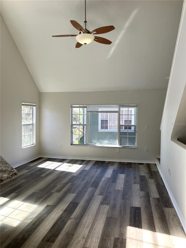 unfurnished living room featuring ceiling fan, high vaulted ceiling, and dark wood-type flooring