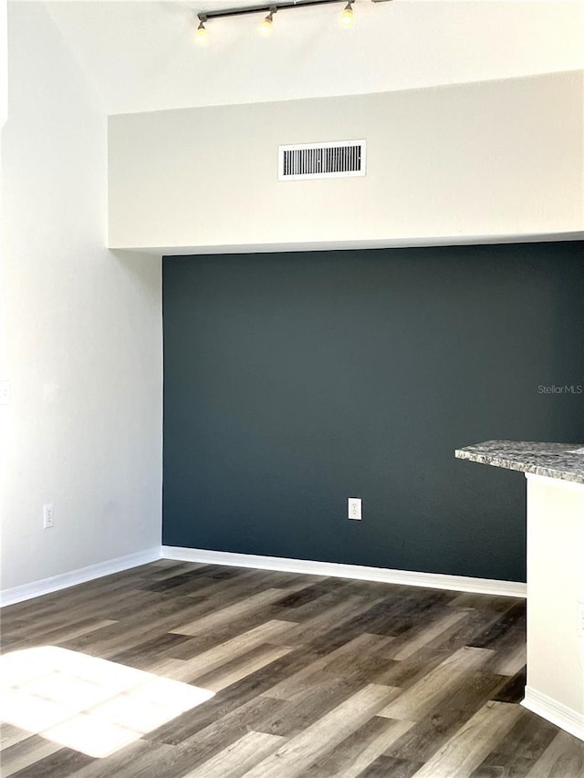 spare room with dark hardwood / wood-style flooring