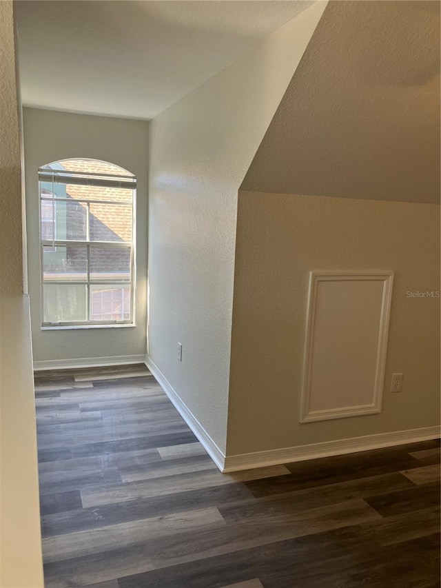 bonus room with dark wood-type flooring