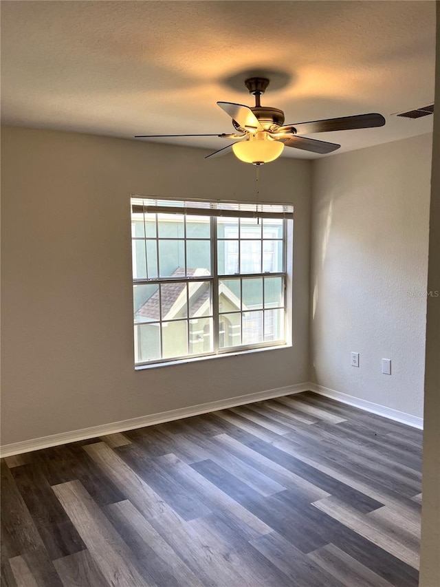 unfurnished room featuring ceiling fan and dark hardwood / wood-style floors