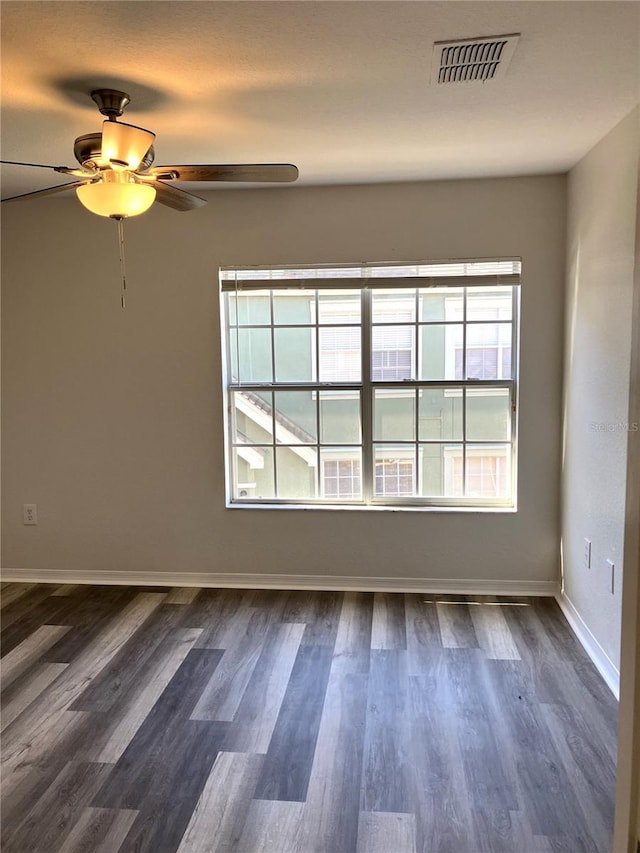 unfurnished room featuring dark hardwood / wood-style floors and ceiling fan