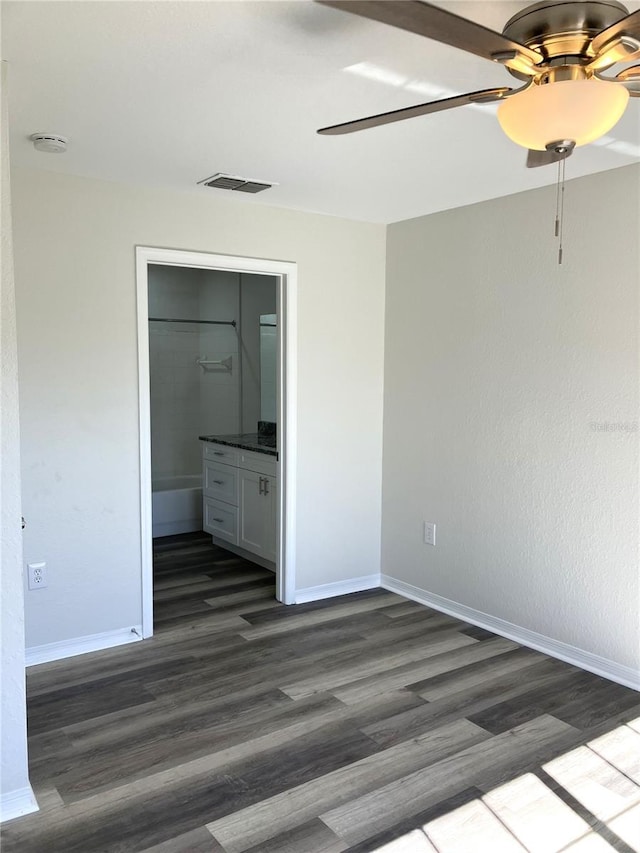 empty room featuring dark hardwood / wood-style floors and ceiling fan