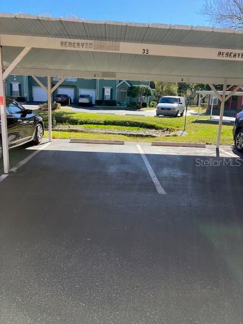 view of parking / parking lot with a carport