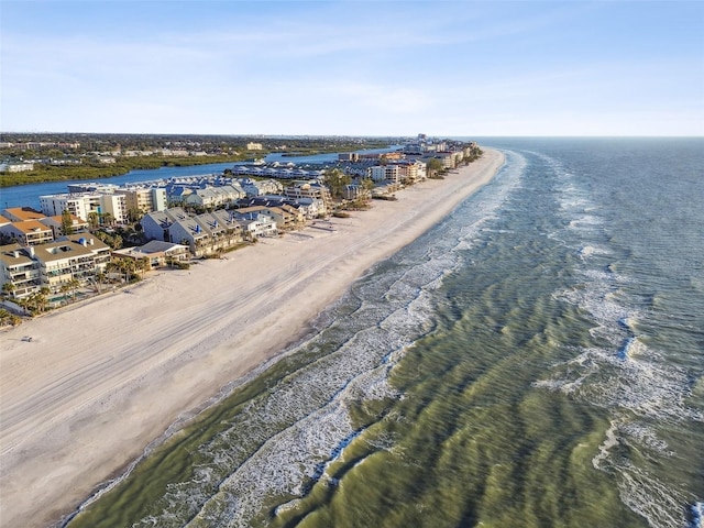 drone / aerial view featuring a water view and a beach view