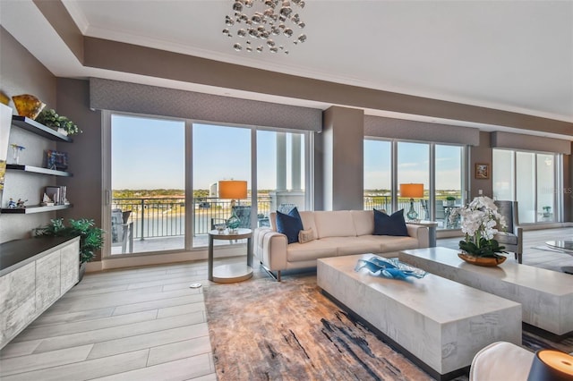 living room featuring crown molding, a water view, and light hardwood / wood-style floors