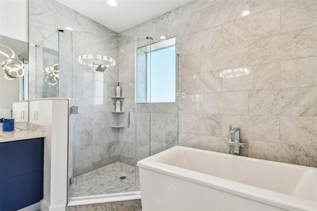 bathroom featuring vanity and shower with separate bathtub