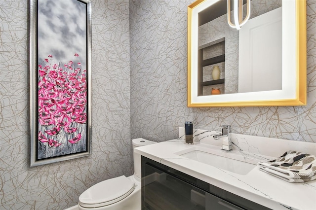 bathroom featuring vanity and toilet