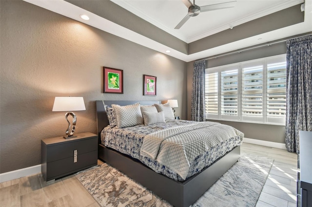 bedroom featuring crown molding, ceiling fan, and light hardwood / wood-style flooring