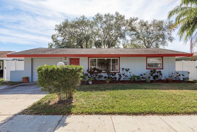 ranch-style home with brick siding, concrete driveway, an attached garage, fence, and a front yard