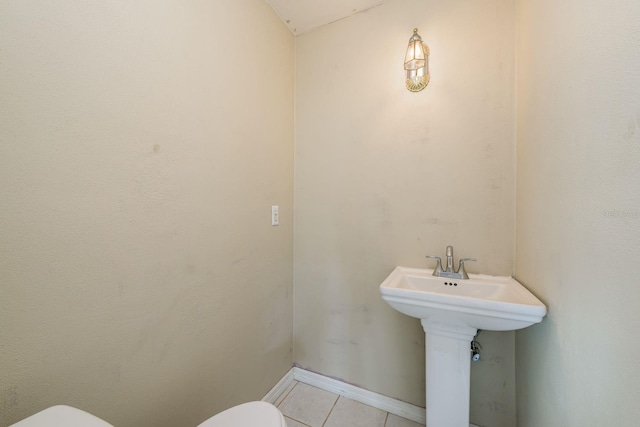 bathroom with tile patterned flooring and toilet