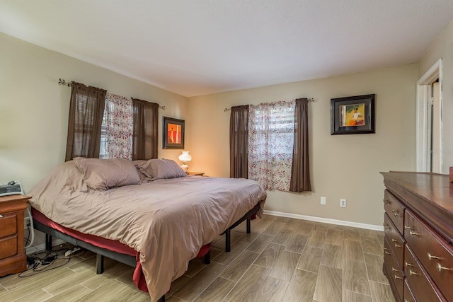 bedroom with wood finish floors and baseboards