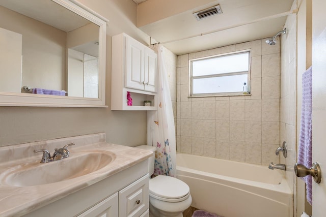 bathroom featuring toilet, visible vents, shower / bath combination with curtain, and vanity