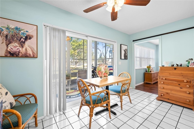 tiled dining room with ceiling fan