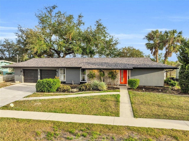 single story home featuring a garage and a front yard