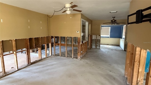 misc room with ceiling fan and concrete flooring