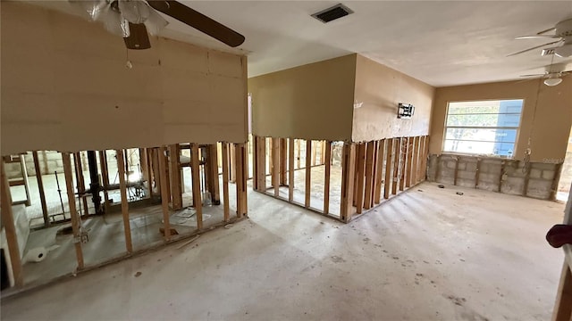 miscellaneous room featuring ceiling fan and concrete flooring